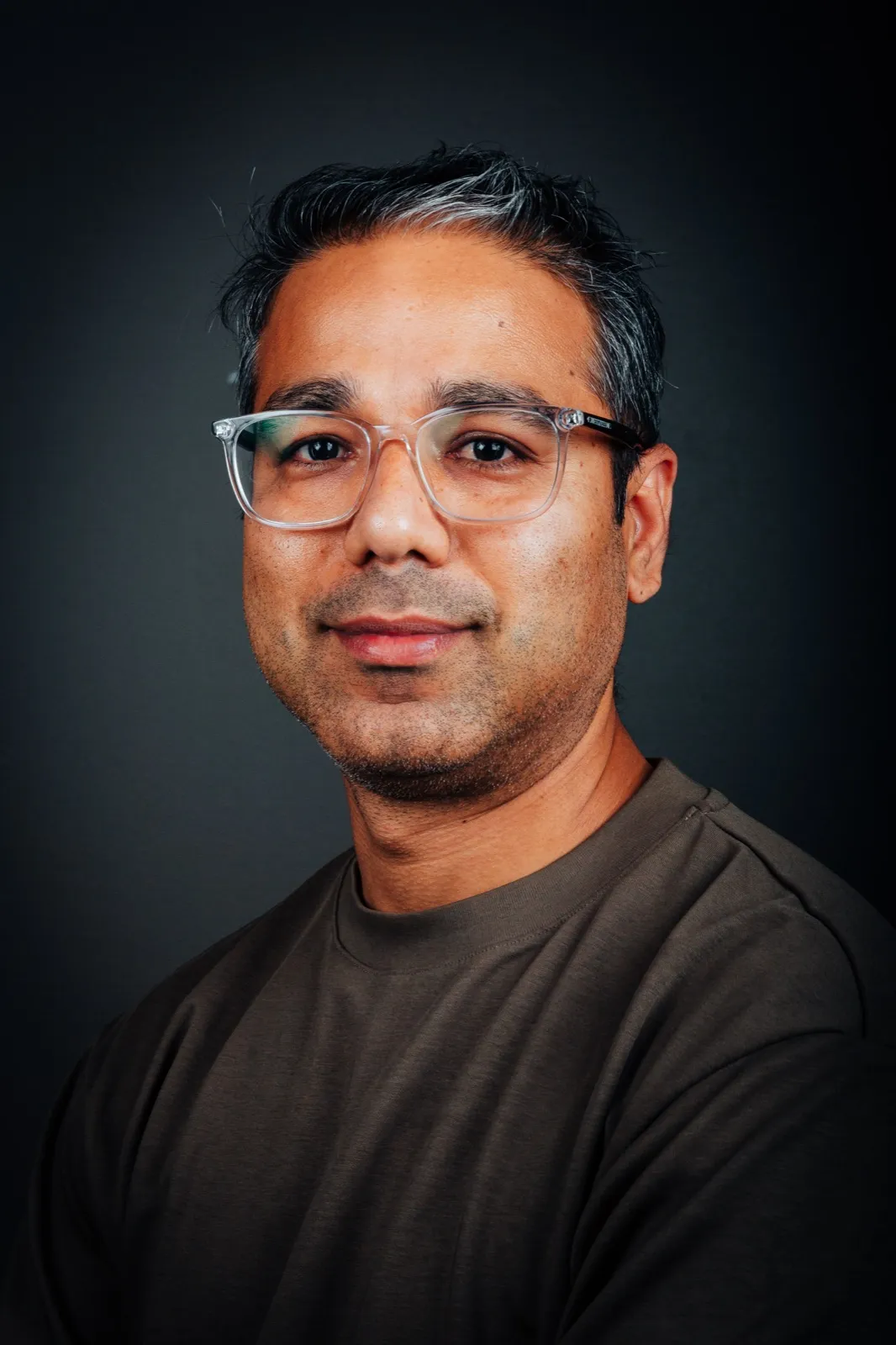 Studio portrait of Nischal Tiwari wearing glasses